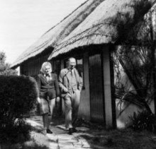 Frances and Nevil outside the thatched boathouse